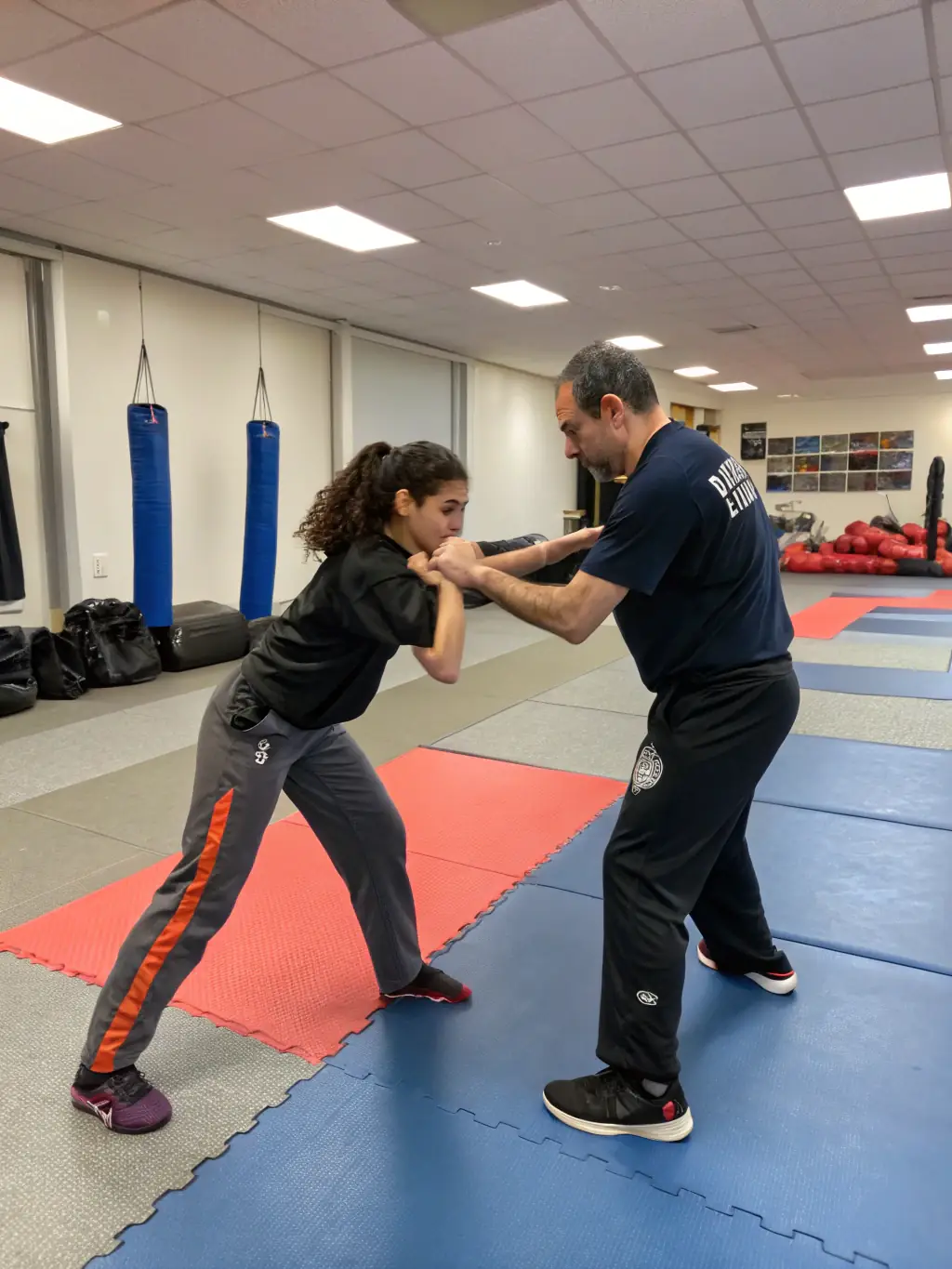 A photo of a contact defense seminar, showing participants learning practical self-defense techniques, to promote the seminar.