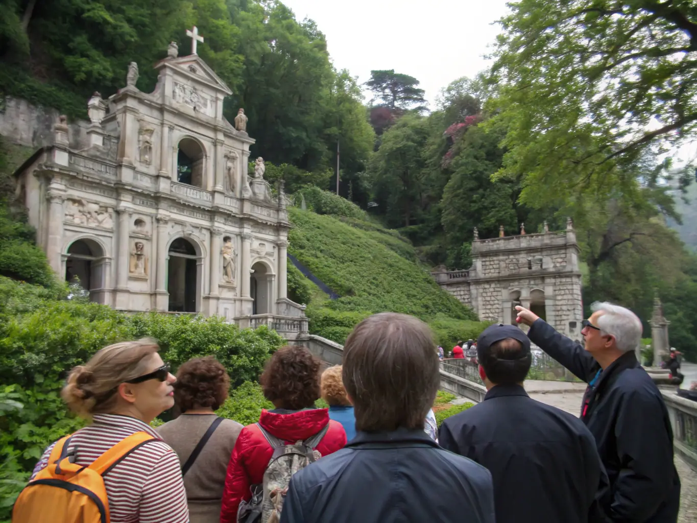 A photograph capturing a guided tour group exploring a historical site in Montluçon, with a knowledgeable guide pointing out architectural details and sharing historical anecdotes.
